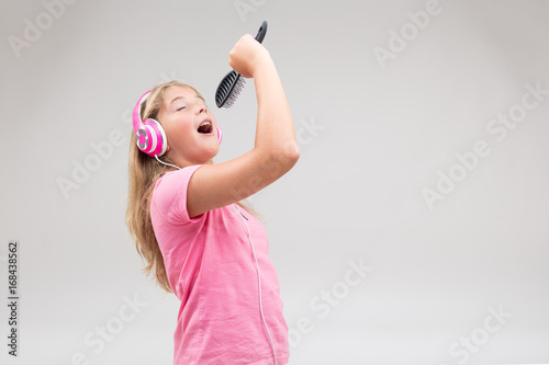 girl with headphones pretending to be a singer