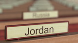 Jordan name sign among different countries plaques at international organization. 3D rendering