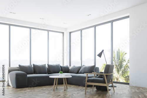 White living room interior with a gray sofa, side