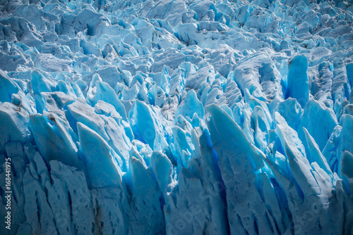 A close-up of the uneven surface of a blue glacier. Shevelev.