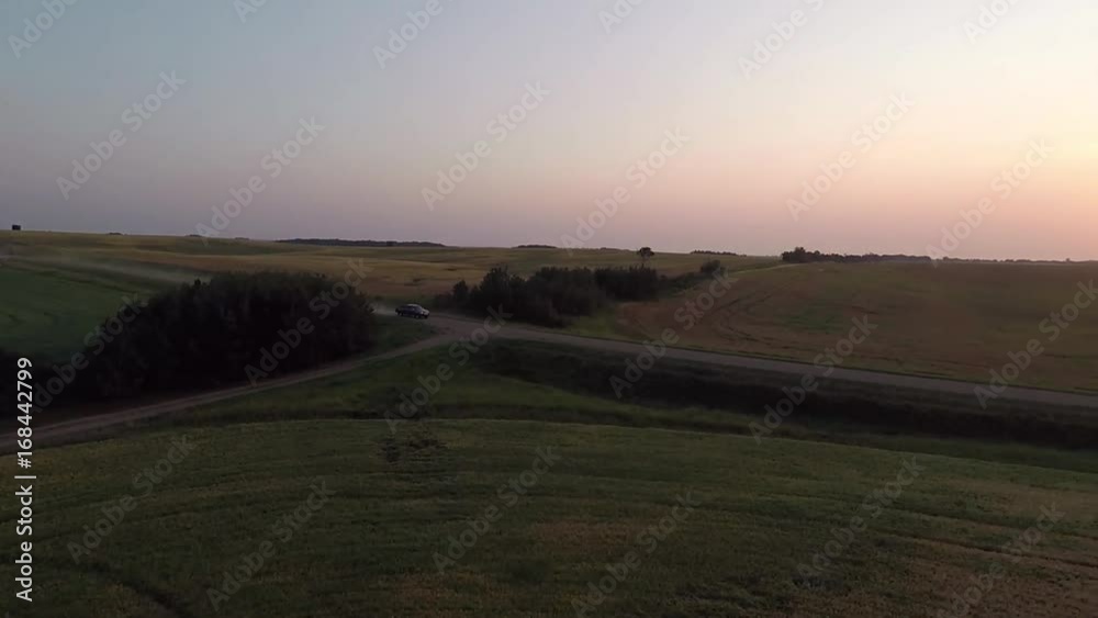 Truck driving down a rural dirt road. Truck driving down a rural dirt road.