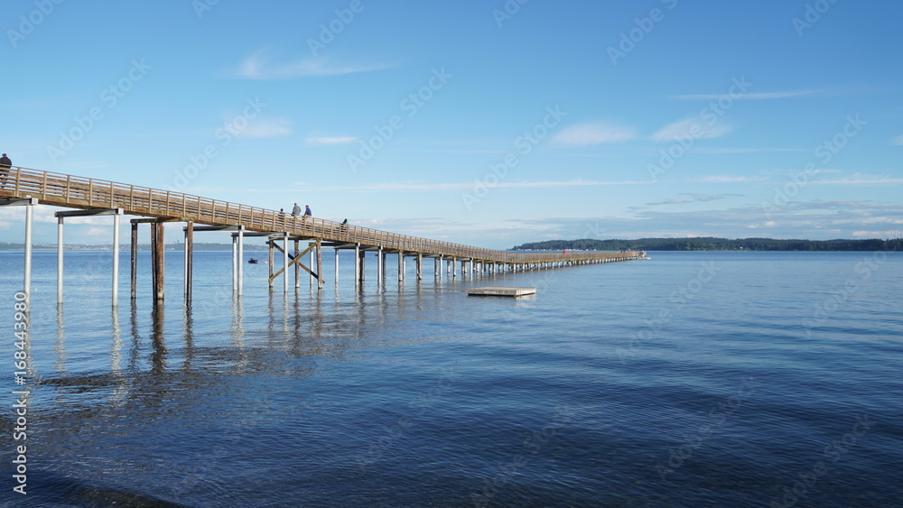 Sky with Pier and body of water in the background