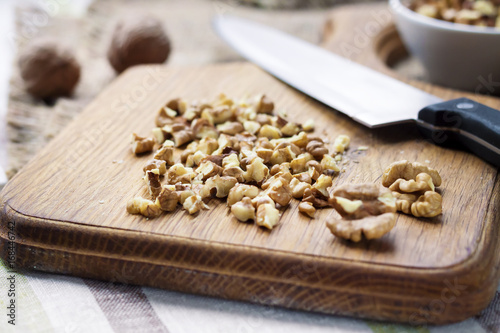 Chopped walnuts on wooden cutting board