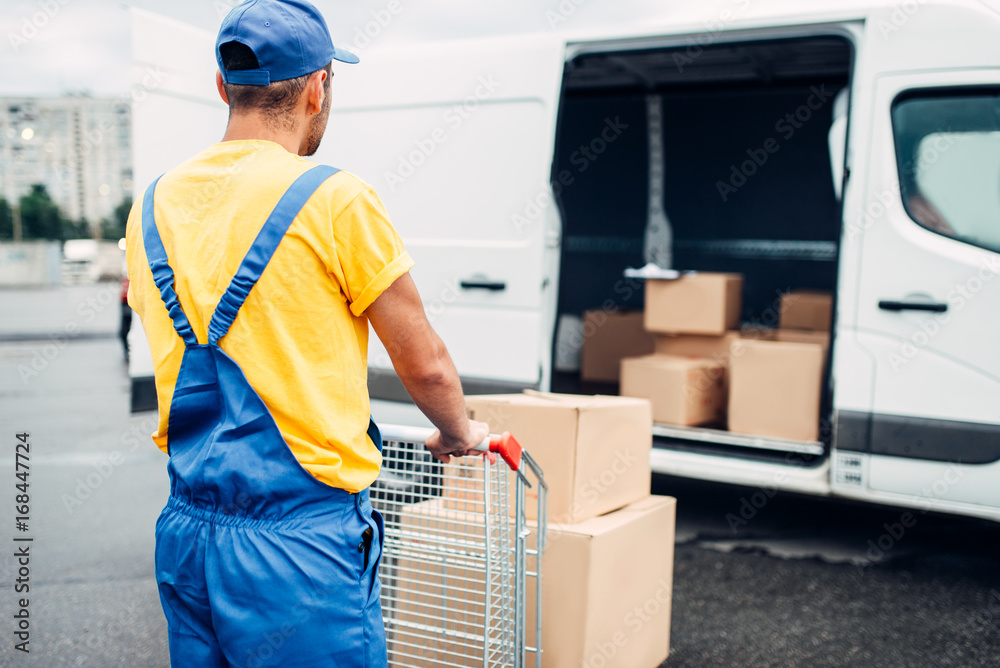 Male courier in uniform work with cargo, back view Male courier in uniform work with cargo, back view