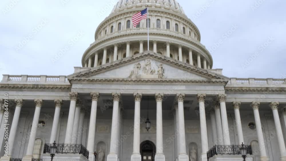 A tilt up establishing shot of the Capitol Building on an overcast summer day. A tilt up establishing shot of the Capitol Building on an overcast summer day.