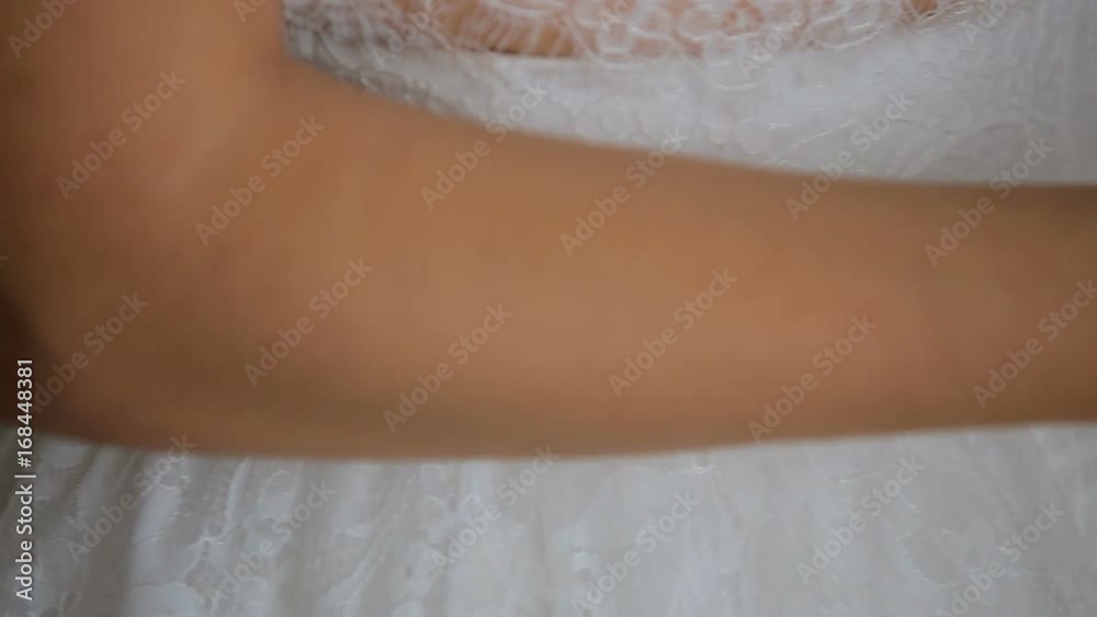 extreme close up of a bride's hand with a figurine of a golden pumpkin with wedding rings. Wedding day