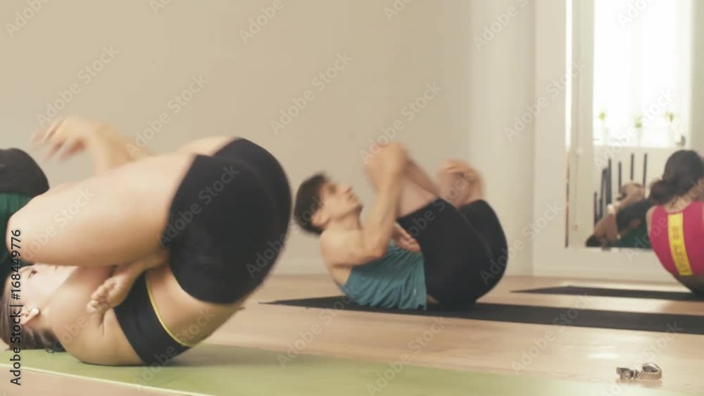 Students performing tolasana in a yoga class