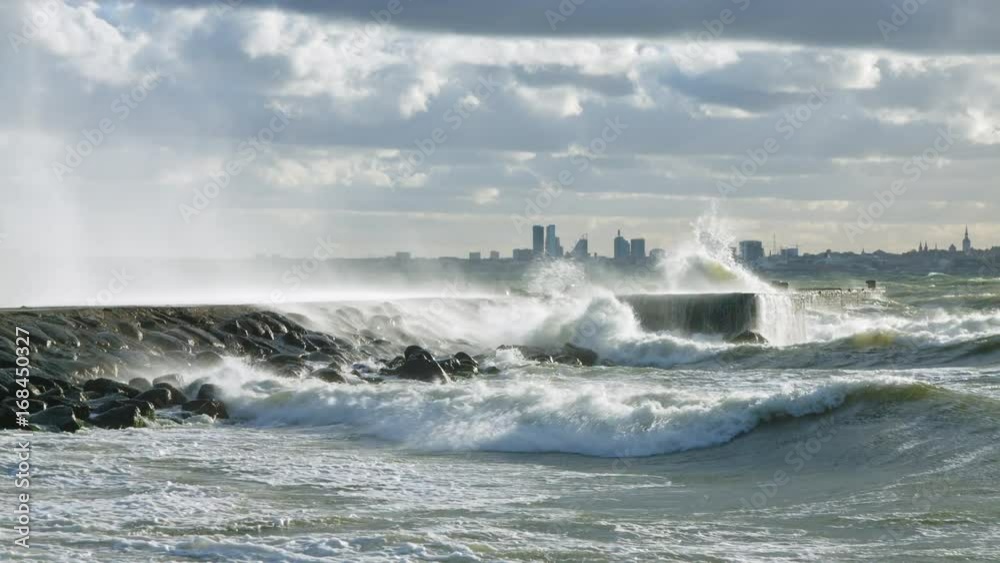 water cascade from waves crashing to the pier