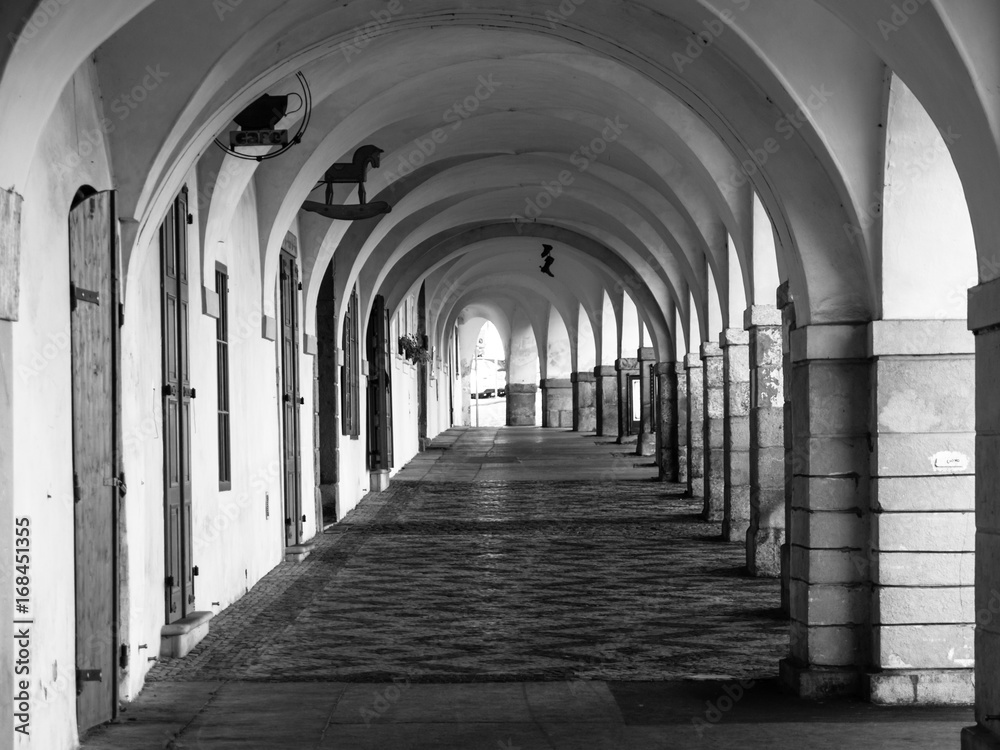 Old historical arcade in Loretanska Street near Prague Castle, Prague, Czech Republic. Black and white image