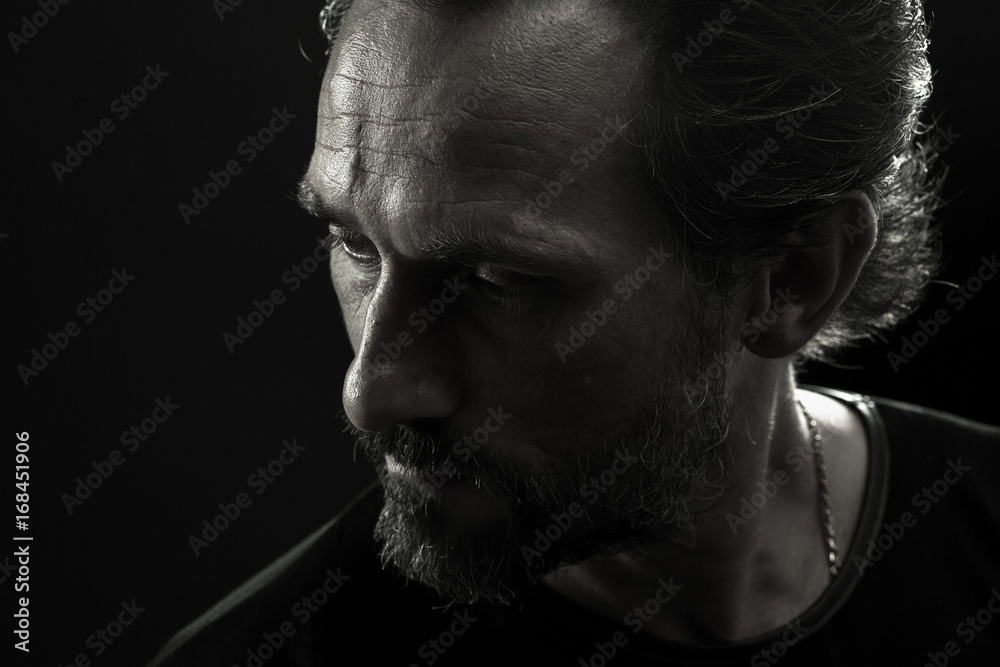 monochrome-portrait-of-strong-man-turnig-face-to-left-side-close-up