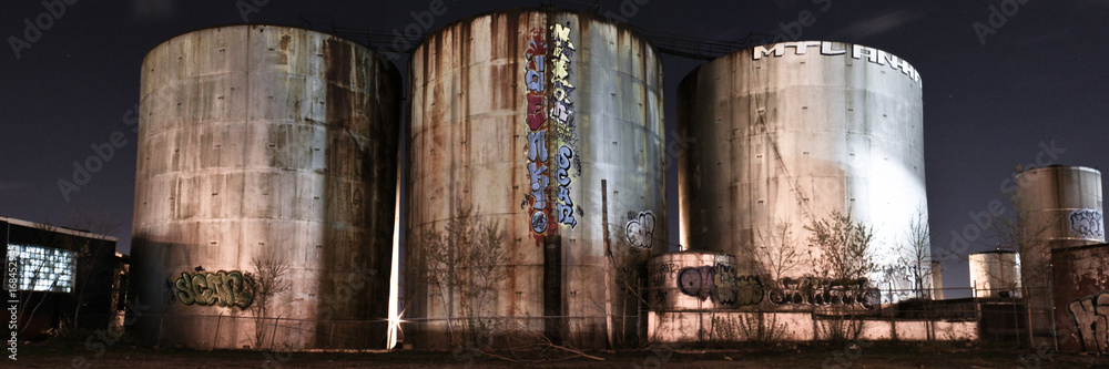 Panorama of abandoned silos at night
