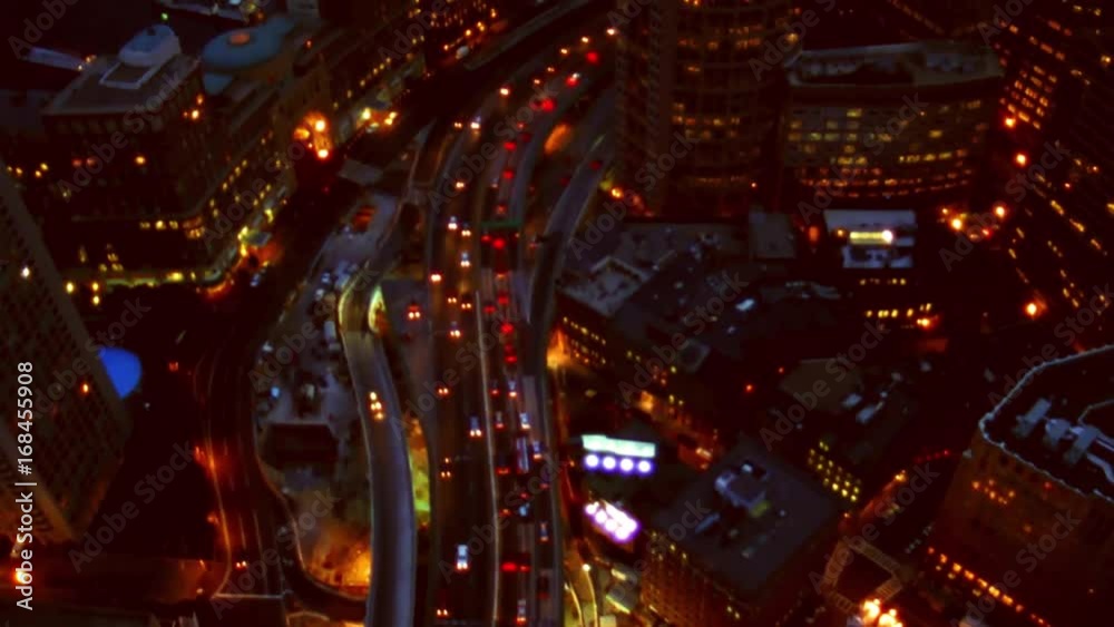Aerial night shot of traffic going through downtown city.