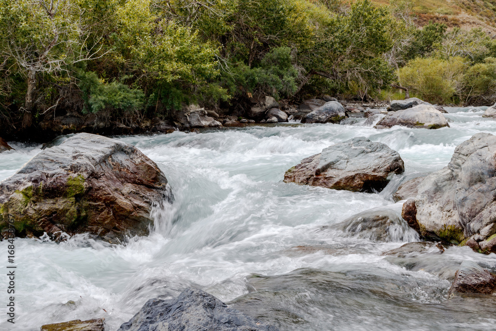 Fototapeta premium in summer rocky mountain river water silk. mountain river