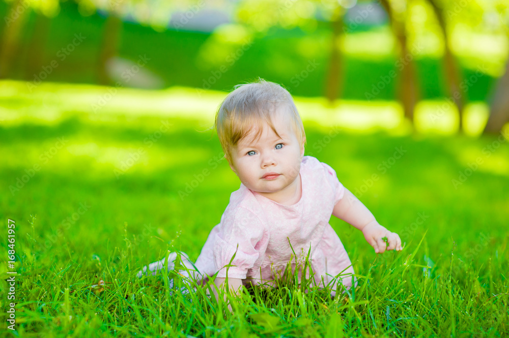 Cute baby crawling on green grass Cute baby crawling on green grass