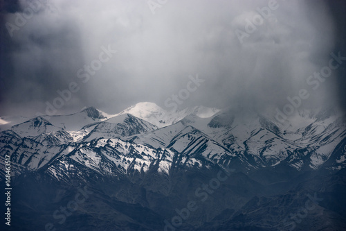 Moutain range covered by dark cloud photo