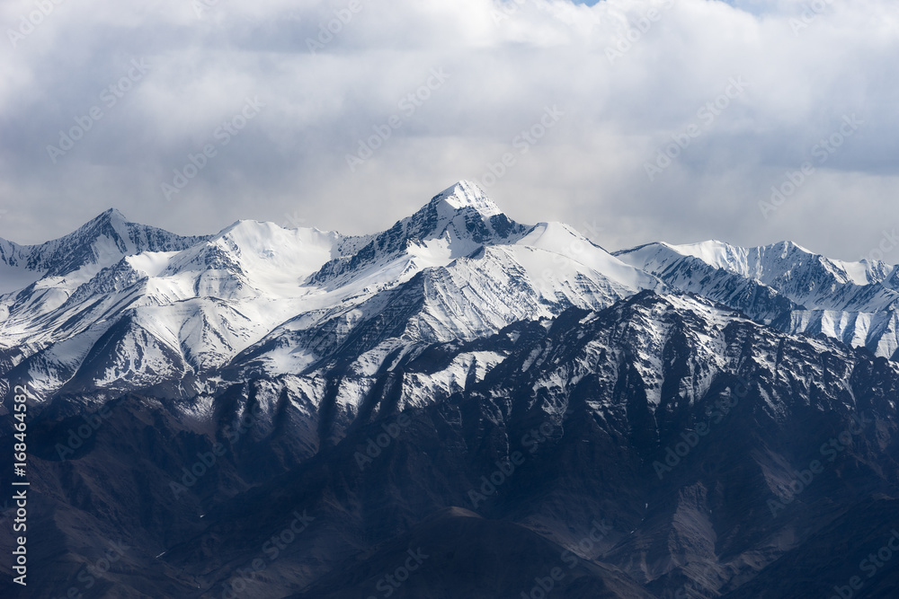Dramatic mountain range and its peak in cloudy sky, Leh Ladakh, India
