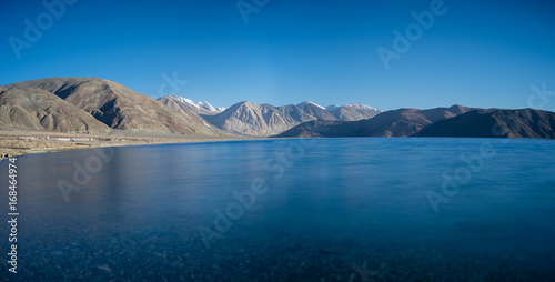 Long exposure panoramic shot of deep blue water of Pangong lake, Ladakh, India