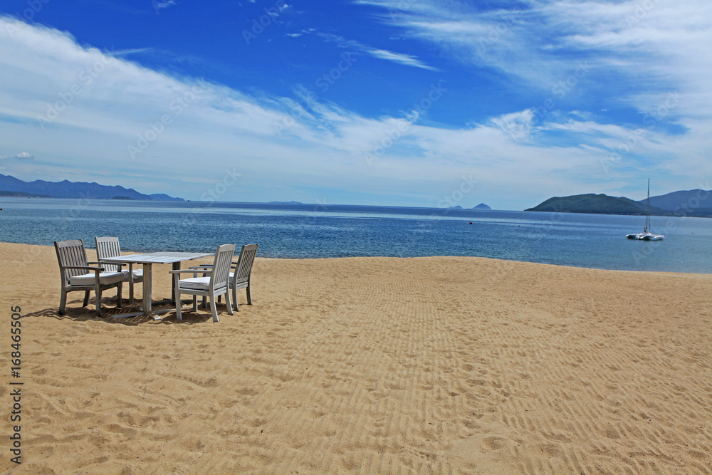 Chairs and table on Nha Trang beach, Vietnam Chairs and table on Nha Trang beach, Vietnam