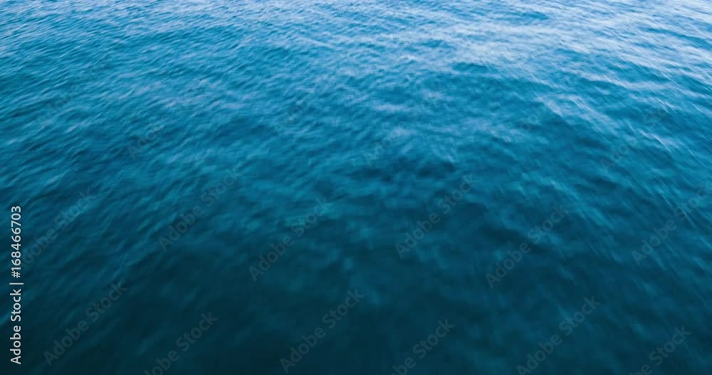 Dramatic Low Flying Aerial Over Blue Ocean Water Dramatic Low Flying Aerial Over Blue Ocean Water