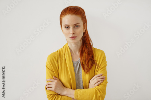 Canvas Print Young Caucasian woman with red hair tied in pony tail, having appealing appearan