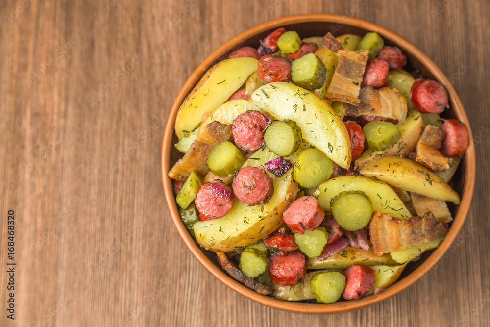 German potato salad with bacon and sausages. The view from the top. Copy-space. German potato salad with bacon and sausages. The view from the top. Copy-space.