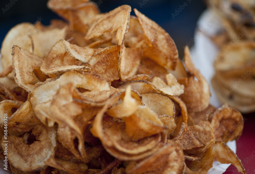 Pile of hot, deep fried potato chips from the midway