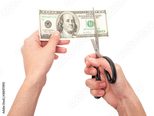 Hands with scissors cutting money