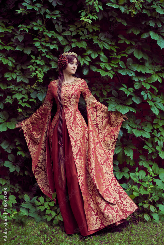Beautiful Isabella of France, queen of England on Middle Ages period in red  gown near medieval castle Stock Photo | Adobe Stock