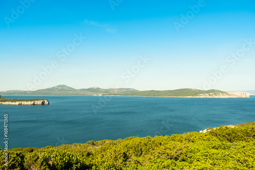 View on the Spanish Tower and the beach Mare Pintau in Sardinia, Italy.