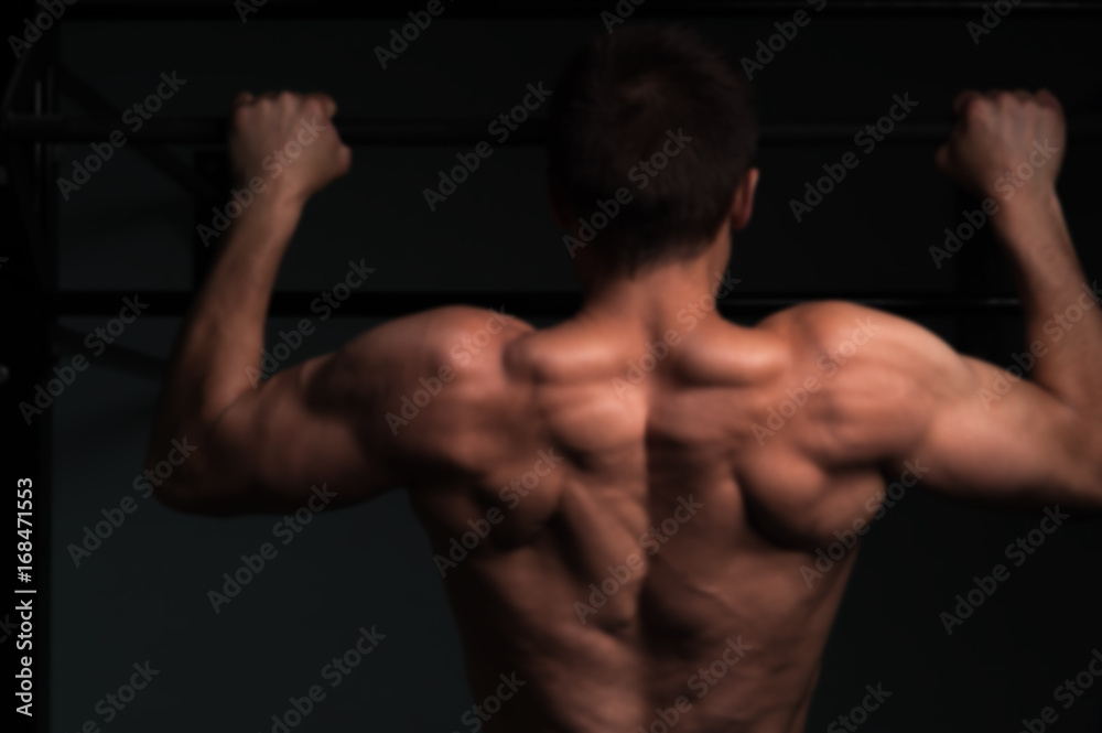 Fitness model with shirtless body doing pull up Fitness model with shirtless body doing pull up