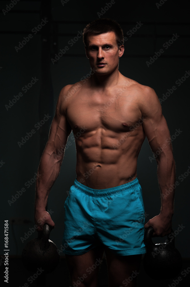 Fototapeta premium Fitness man with shirtless body posing in gym