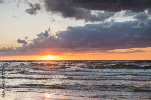Summer sunset over Baltic sea with dramatic cloud sky. 