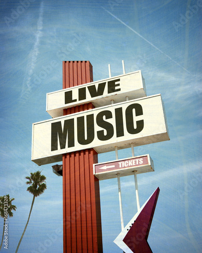 aged and worn vintage photo of live music sign with palm trees