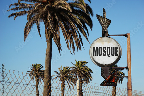 aged vintage mosque sign with palm trees 