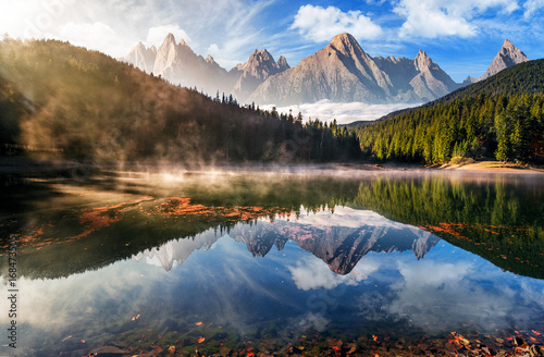 gorgeous mountain lake in autumn fog