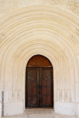 Background of ancient entrance to the castle: old wooden doors with arches
