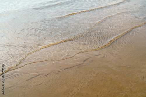 Fototapeta Naklejka Na Ścianę i Meble -  small waves on sandy beach closeup