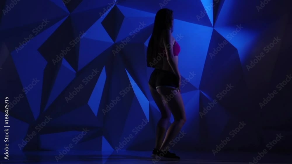 Dance twerk from professional dancer on a blue graphic background. Slow motion