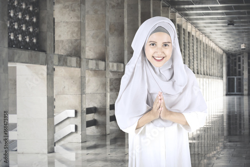 Muslim woman with welcoming gestures
