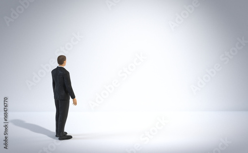 toy miniature businessman figure standing and looking at an empty white lit space, concept background © dottedyeti