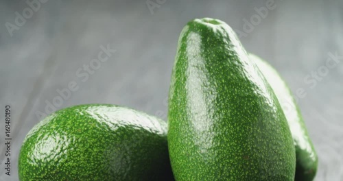 ripe green avocados on wood table photo
