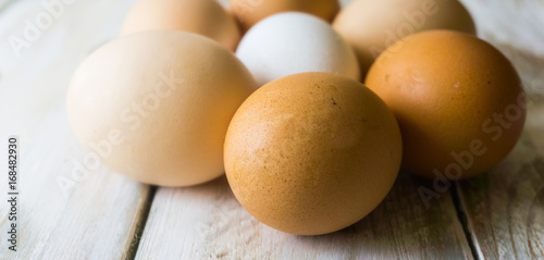 Close up of fresh chicken egg on nature wooden table