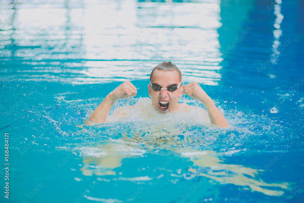 Male swimmer at the swimming pool. Underwater photo