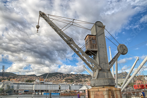 GENOA (GENOVA), AUGUST, 10, 2017 - View of an old industrial crane in the ancient port of Genoa (GEnova), Italy, under a cloudy sky.