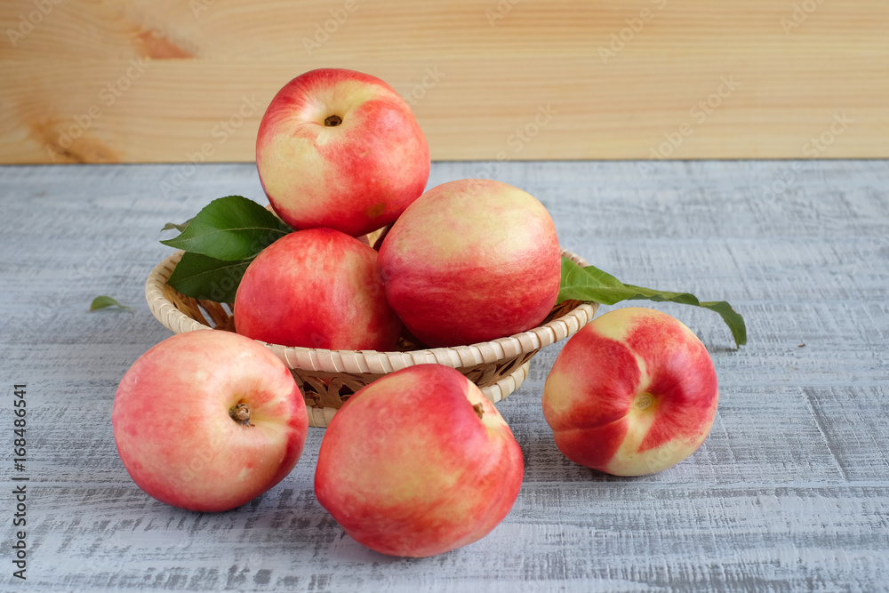 Ripe fresh nectarines in the wicker basket