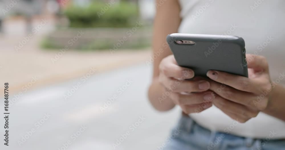Touching on mobile phone at outdoor Touching on mobile phone at outdoor