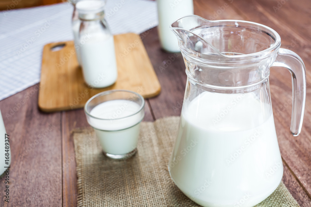 milk and glasses of milk on a wooden rustic table. milk and glasses of milk on a wooden rustic table.