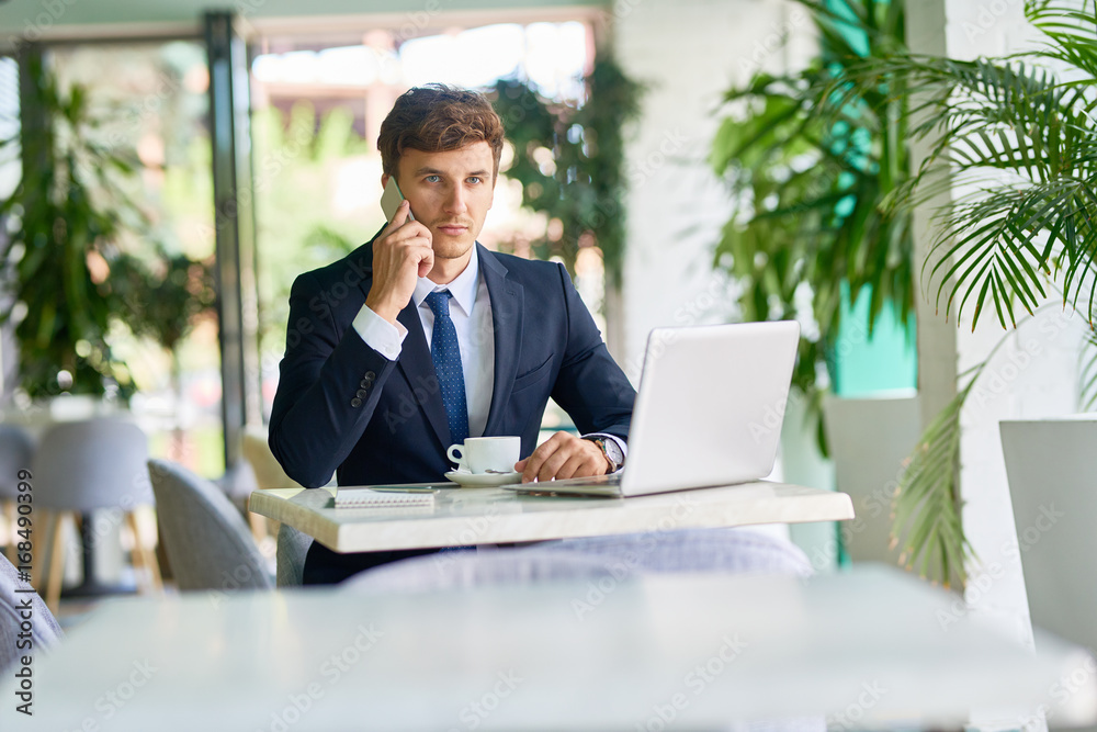 Contemporary Businessman Working in Cafe Contemporary Businessman Working in Cafe