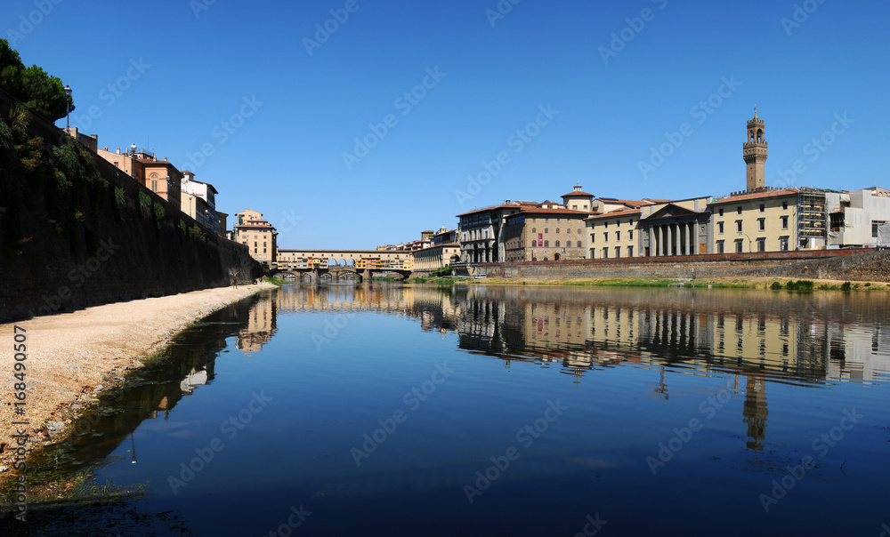 Panoramic view of famous Old Bridge (Ponte Vecchio) and Old Palace (on the right) at Florence, Italy.