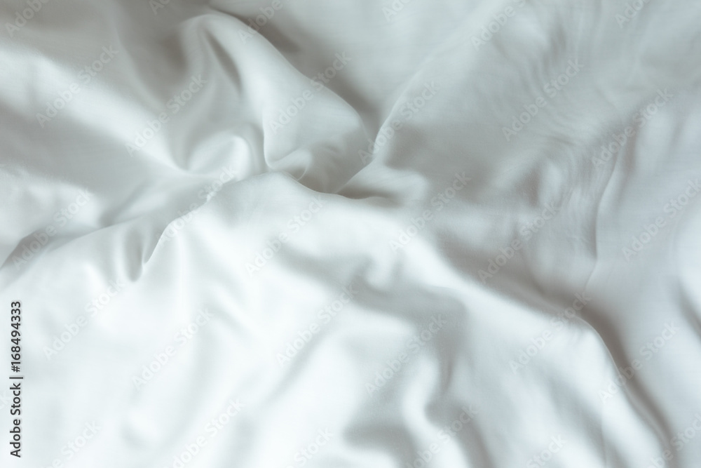 Obraz premium Top view of white bedding sheets after wake up in the morning